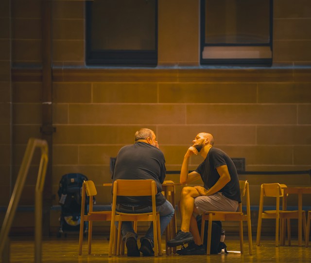Two men talking at a table.